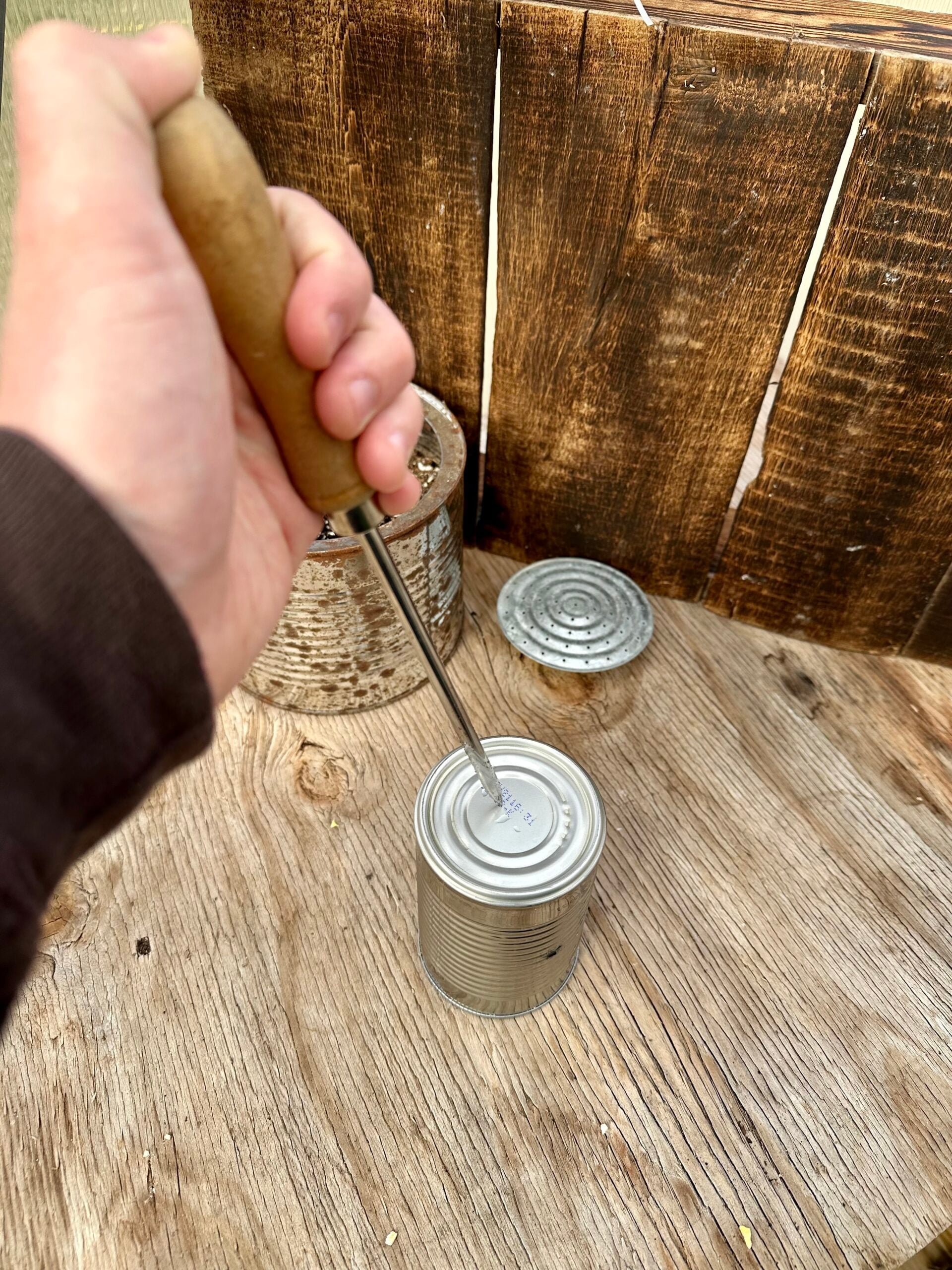 Making drainage holes on a can